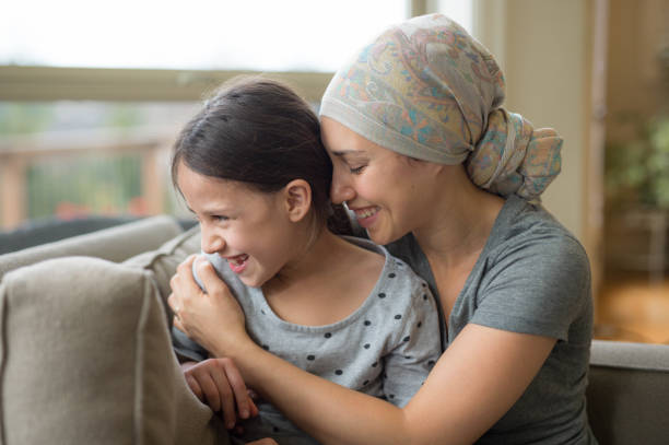 istock Ethnic young mom with cancer holding daughter 672689858