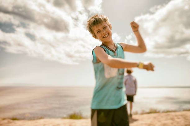 istock Playful and silly child at the ocean 672690024