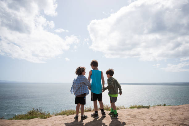 istock Holding hands over the ocean 672690054