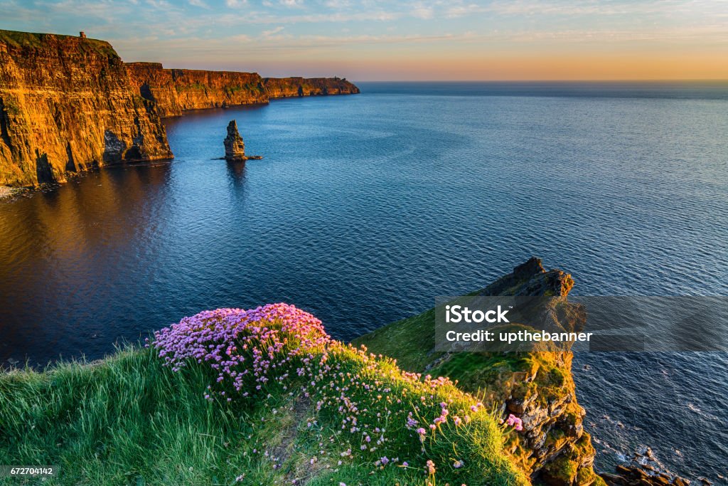 The Cliffs of Moher West coast of Ireland Ireland Irish world famous tourist attraction in County Clare. The Cliffs of Moher West coast of Ireland. Epic Irish Landscape and Seascape along the wild atlantic way. Beautiful scenic nature from Ireland. Cliffs of Moher Stock Photo