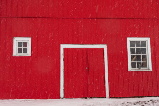 istock Red barn on the Prairies on a snowy day 672704700