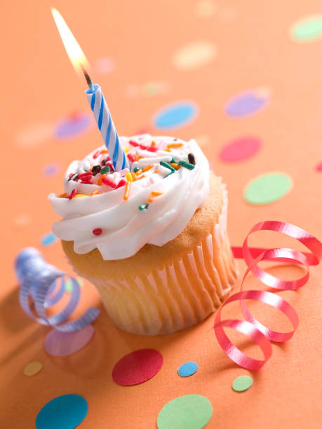 Cupcake with candle and confetti