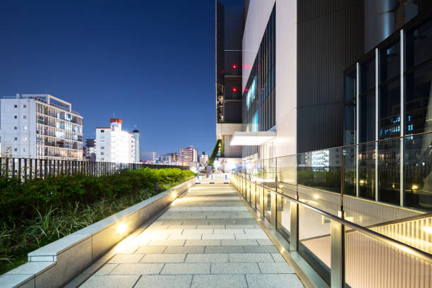 istock empty footpath outside of modern building at night 672711456