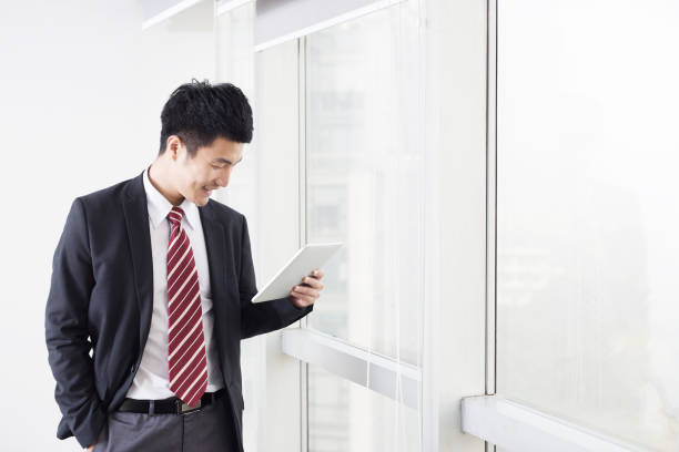 istock handsome asian businessman in modern office 672714850