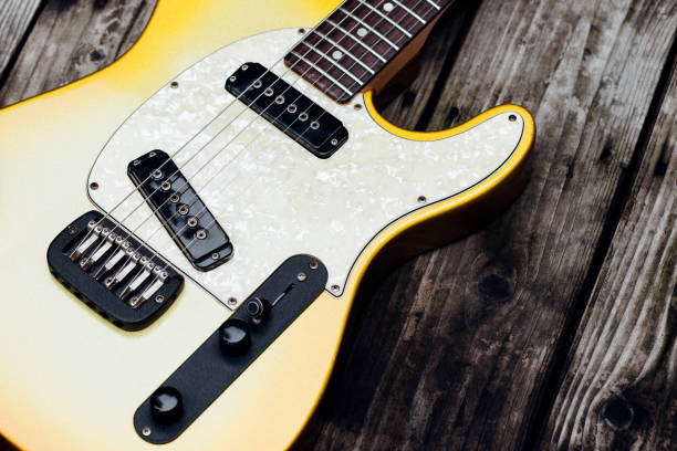 istock Yellow Electric Guitar on Wood 672716954