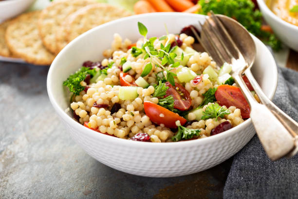 istock Pearl couscous salad with fresh vegetables 672718196