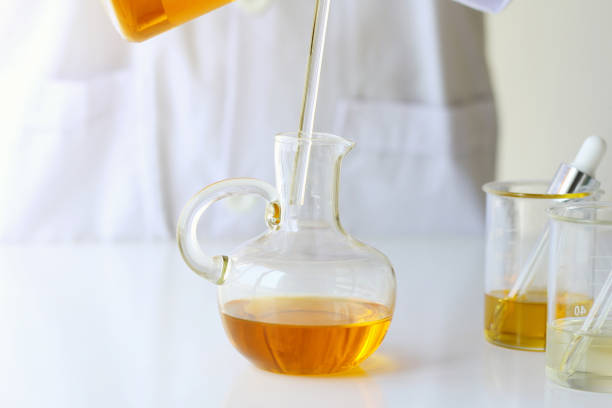 istock Beauty cosmetics sciences, Formulating and mixing skincare with herbal essence, Scientist pouring organic essential oil 672724736