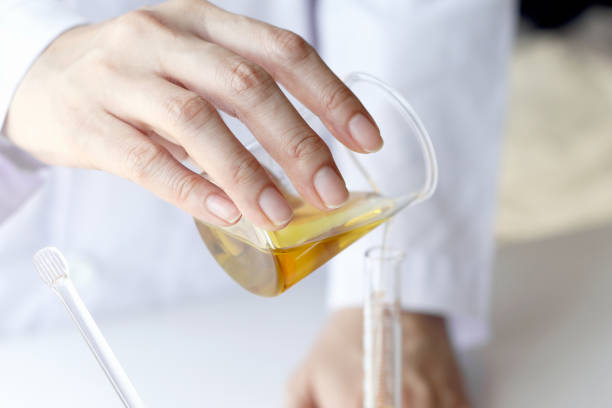istock Beauty cosmetics sciences, Formulating and mixing skincare with herbal essence, Scientist pouring organic essential oil 672724780