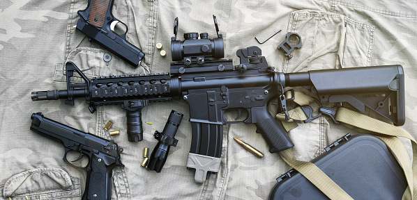 Weapons and military equipment for army, Assault rifle gun (M4A1) and pistol on camouflage background.