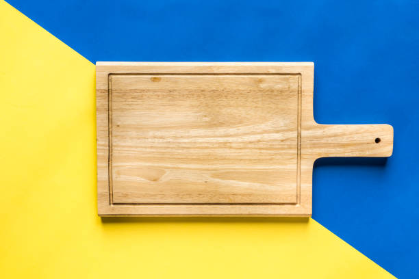 istock Top View of Cutting Board over Colorful Background 672728948