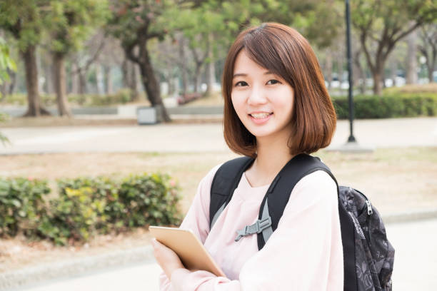 istock Cheerful woman wanderer with trendy look searching direction on location map 672734412