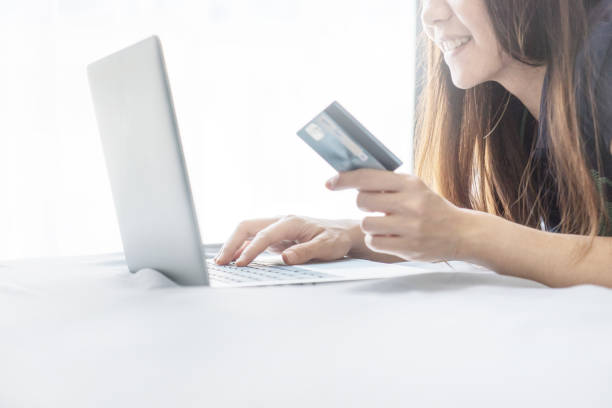 istock Hand using laptop and holding credit card 672738212
