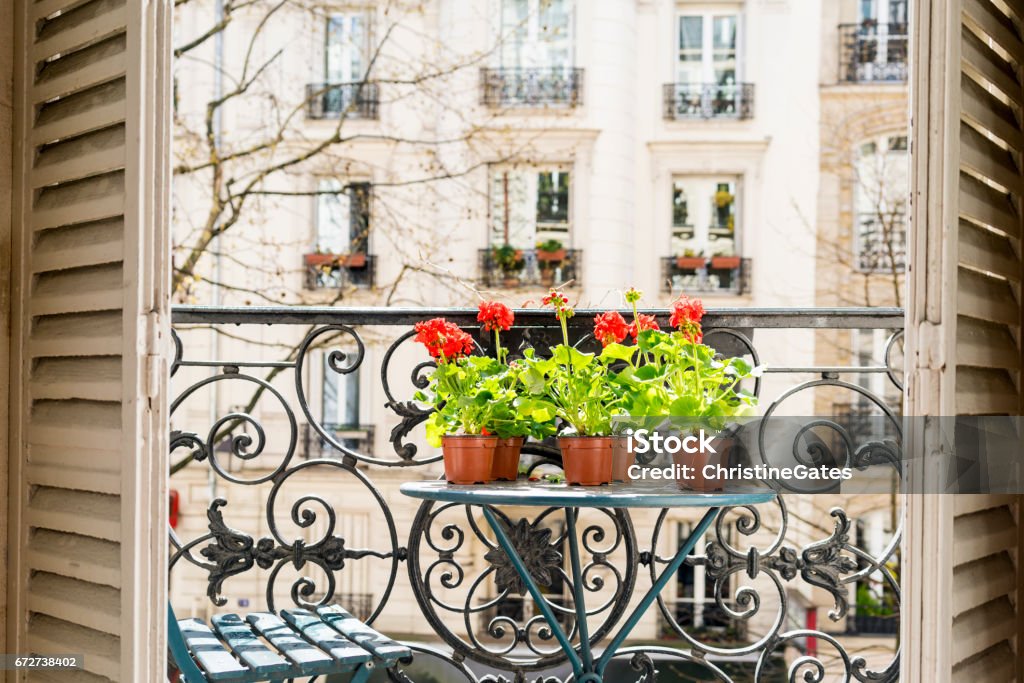 Springtime with red geraniums on a Paris balcony Balcony Stock Photo