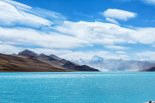 tibet holy lake with snow mountain, blue sky more photo stack