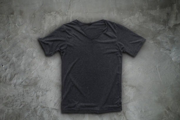 Grey t-shirt on concrete wall background.