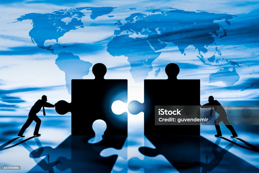 World Business teamwork puzzle pieces Mergers and Acquisitions Stock Photo