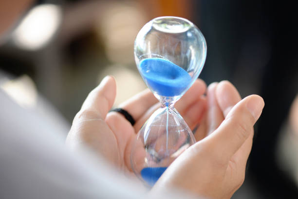 istock Hourglass that is located on the beautiful hands. 672768294