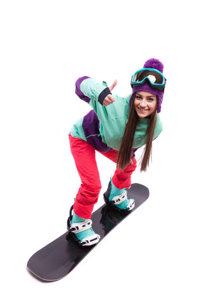 istock young woman riding snowboard 672768540