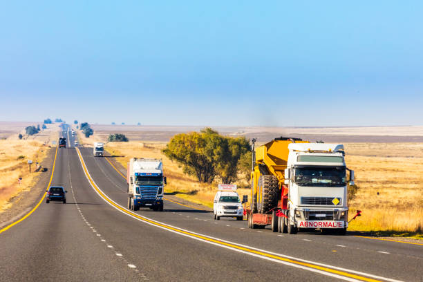 istock Heavy Cargo on the Road transporting construction machinery 672778860