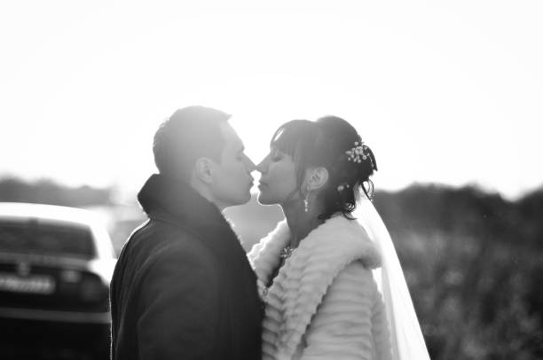 kissing wedding couple on the backlight - silhouette kissing park sunset imagens e fotografias de stock