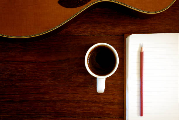 istock notebook, pencil and coffee cup with acoustic guitar 672785264