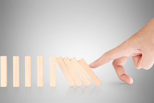 istock hand stop  dominoes continuous toppled 672788630