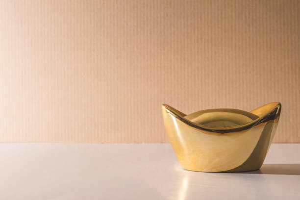 istock Chinese gold ingots on the table, Free space for text 672789102