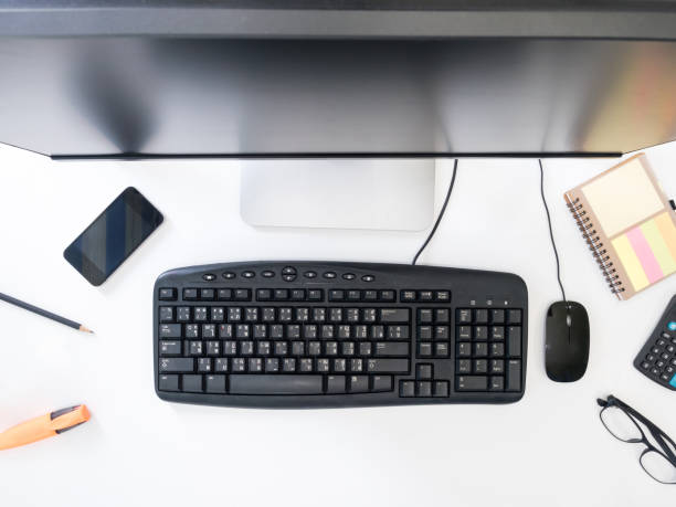 istock Top view of Desktop computer with office supplies on white background. 672792118