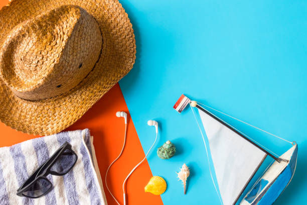 istock Top view of beach accessories on colorful background. 672792450