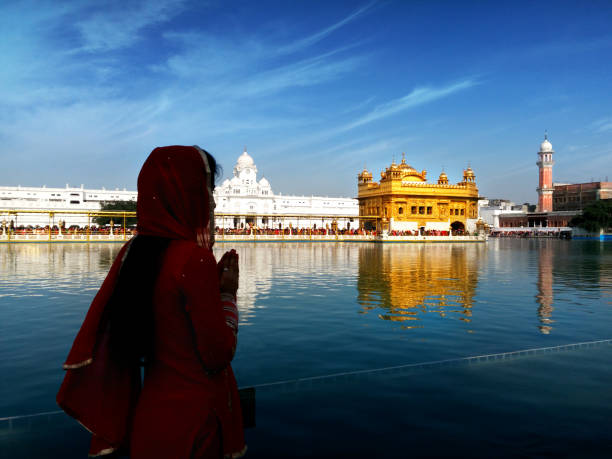 istock Praying to god in golden temple 672793724