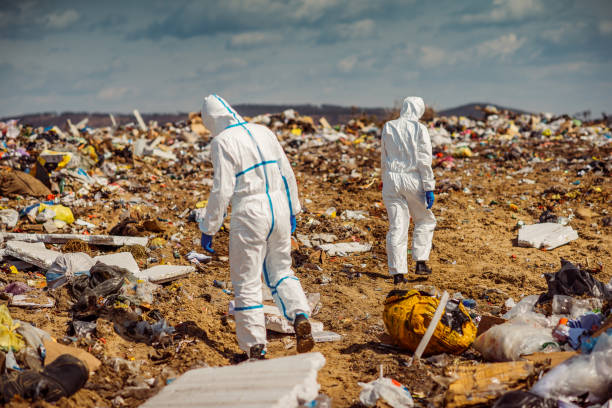 istock Recycling workers researching on the landfill 672793800