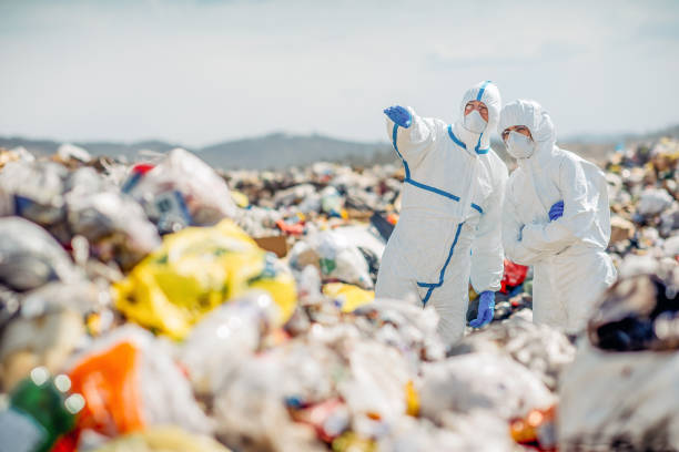 istock Recycling workers researching on the landfill 672793802