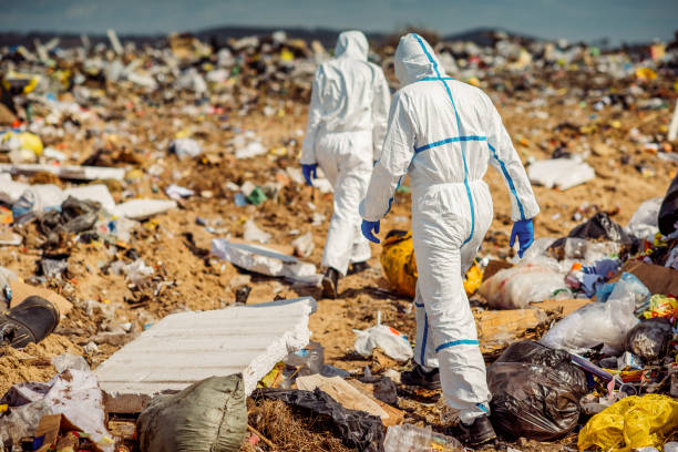 istock Recycling workers researching on the landfill 672793804