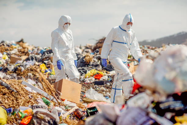 istock Recycling workers researching on the landfill 672793806