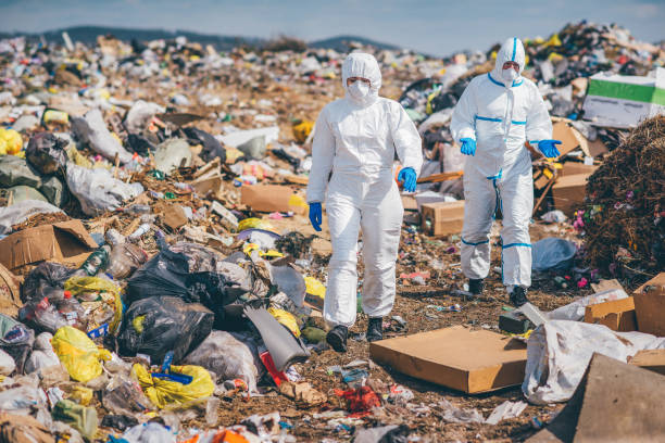 istock Recycling workers researching on the landfill 672793814