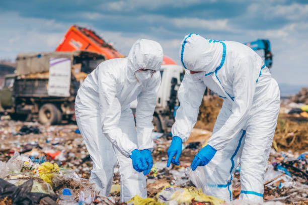 istock Recycling workers researching on the landfill 672793834