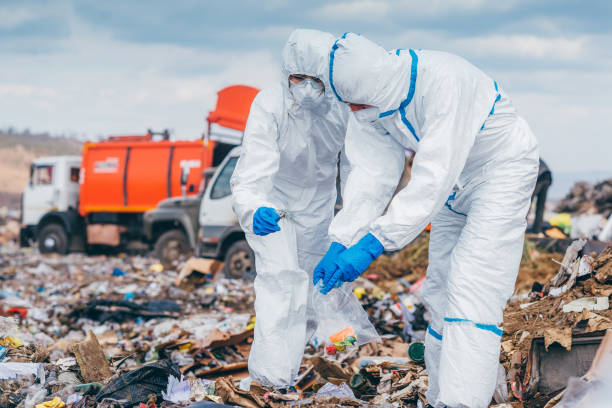 istock Recycling workers researching on the landfill 672793848