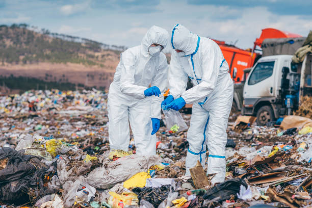 istock Recycling workers researching on the landfill 672793850