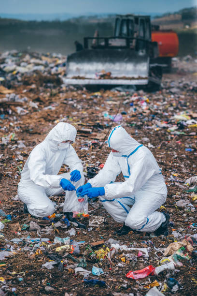 istock Recycling workers researching on the landfill 672793876