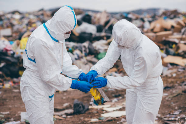 istock Recycling workers researching on the landfill 672793878