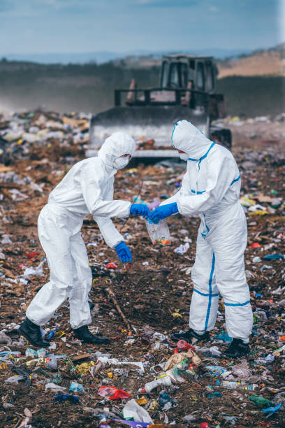 istock Recycling workers researching on the landfill 672793882