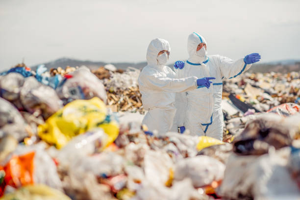 istock Recycling workers researching on the landfill 672793886