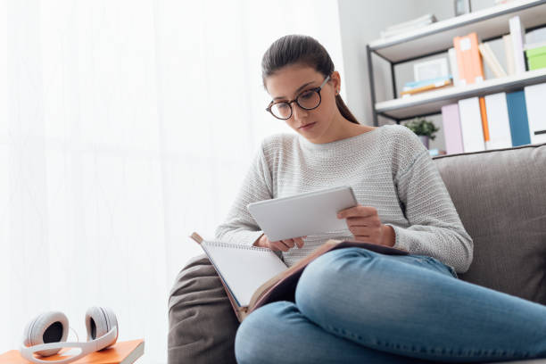 istock Girl studying and connecting with a tablet 672799482