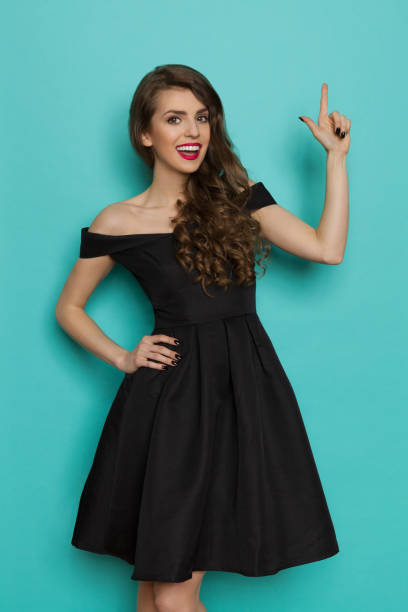 istock Elegant Woman Pointing Up And Talking 672801962