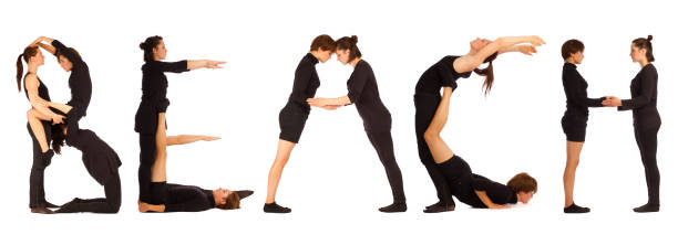 Black dressed people forming word BEACH stock photo