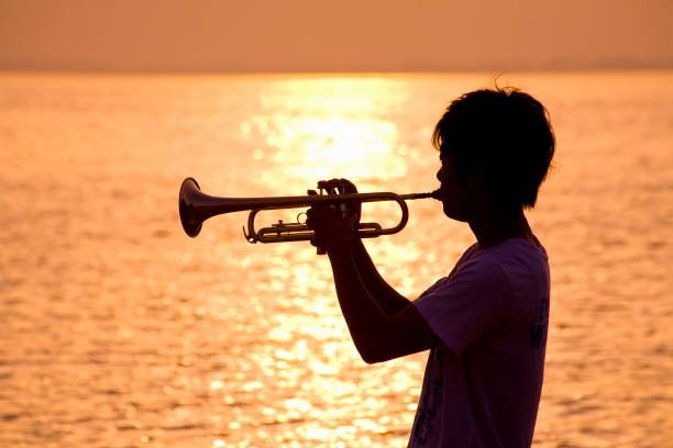 istock Playing the trumpet silhouette 672810328