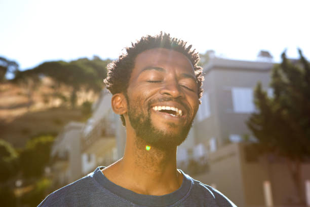 istock Close up handsome calm man outside with eyes closed 672810422