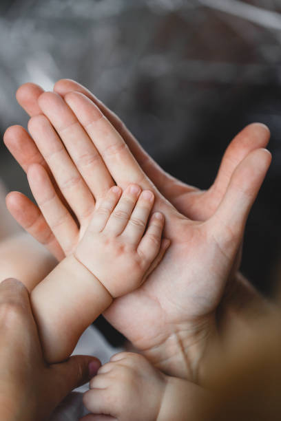 istock Father and Mother Holding Newborn Kid. 672827338