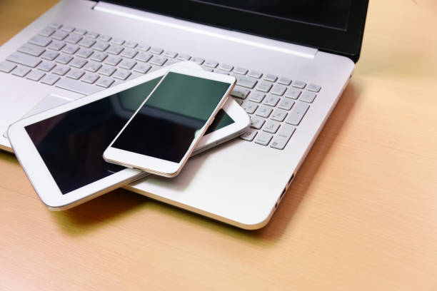 istock Laptop computer notebook tablet and smart phone on wooden background 672828374