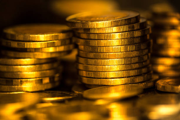 istock gold money coin stacking on dark background 672836966